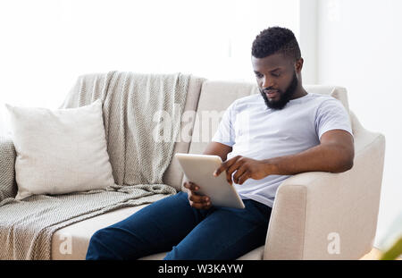 Young african american man using digital tablet Stock Photo