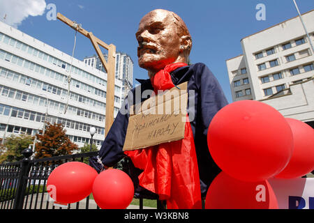 A sculpture of Soviet Union founder Vladimir Ilyich Ulyanov, known as Lenin in front of the Ukrainian Constitutional Court building during a protest in Kiev.The activists protest against the cancellation of the laws on de-communization adopted by the Ukrainian Parliament on April 2015. 46 Ukrainian lawmakers, mostly supporters of former Russia-backed President Viktor Yanukovych, addressed the court to repeal the laws 'on the cleansing of power' and 'on condemnation of the communist and national socialist (Nazi) totalitarian regimes in Ukraine and the prohibition of their symbols. Stock Photo