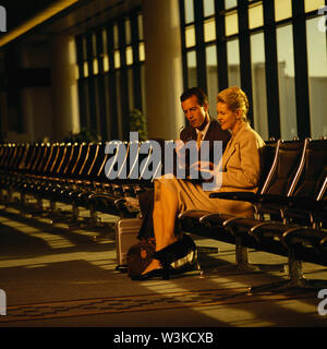 Businessman and businesswoman working at the airport Stock Photo