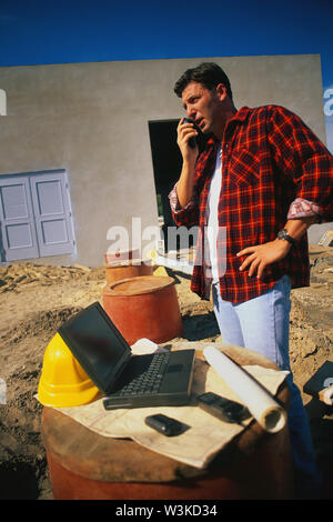 Construction worker  on his phone Stock Photo