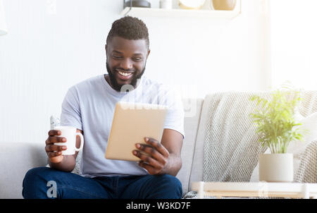 Young man using tablet, having video chat Stock Photo