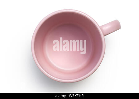 Empty pink ceramic mug isolated on white from above. Stock Photo