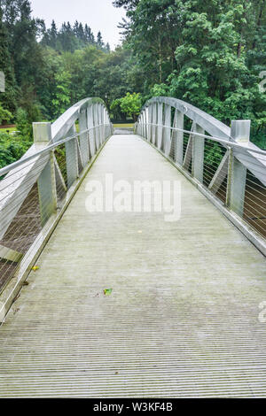 A walking bridge gives access to Maplewood Park in Renton, Washington. Stock Photo