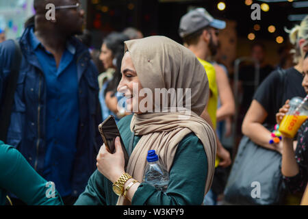 Arabic young woman on Oxford Street smiling and looking very happy Stock Photo