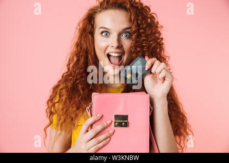 Unrecognizable woman putting yellow credit card in red pants pocket Stock  Photo by Prostock-studio