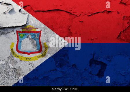 Sint Maarten flag painted on the cracked grunge concrete wall Stock Photo