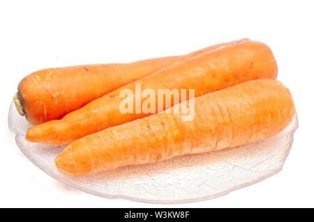Carrots on a plate isolated on white Stock Photo