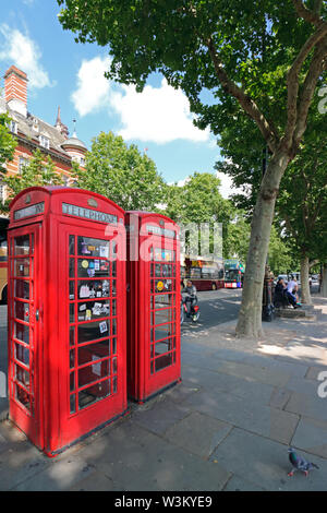 Two iconic red telephone boxes on the Victoria Embankment in London England Uk. Stock Photo
