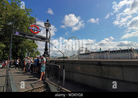 Westminster underground station entrance on the Victoria Embankment across the Thames from the London Eye and County Hall in London England UK Stock Photo