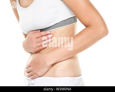 Stomach pain. Woman having abdominal pain upset stomach or menstrual cramps. Close up of young female model isolated on white background. Stock Photo