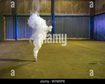 Pre-harvest fumigation of an agricultural grain store using an Actellic Smoke Generator No. 20 in order to prevent spoilage of grain by pest insects Stock Photo