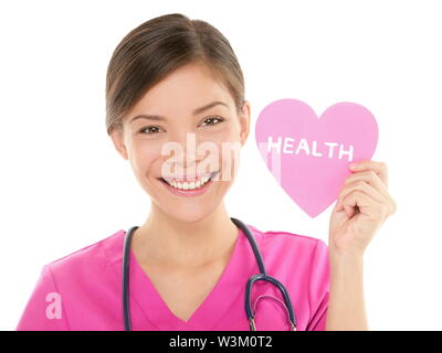 Medical nurse doctor woman showing HEALTH sign on heart. Health care concept with friendly happy multiracial Asian Chinese / Caucasian female medical professional isolated white background in scrubs.