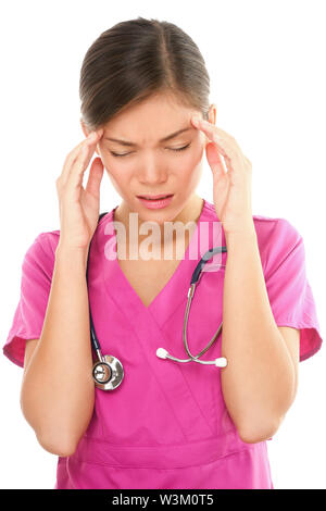 Nurse with headache stress. Nurse / doctor with migraine headache overworked and stressed. Health care professional in pink scrubs wearing stethoscope isolated on white background. Stock Photo