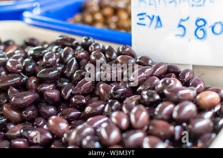 Traditional greek food ingredient, green olives in box on farmer market close up Stock Photo