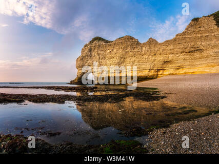 Beautiful and scenic landscape of the Falaise d'Amont at dusk or sunset, famous cliff of the Normandy Coast, Etretat, France. Stock Photo