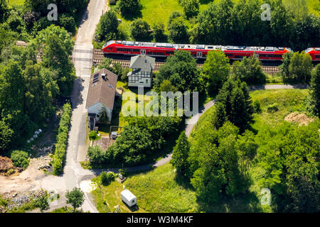 Aerial view of the unrestricted level crossing with former railway station house at Rumbeckerhammer Rumbeck in Arnsberg in Sauerland in the state of N Stock Photo