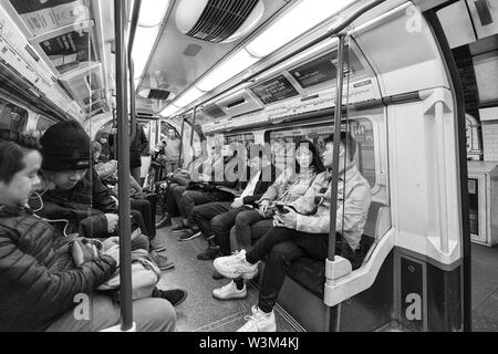 Passengers on a London Underground / London Tube eastbound Piccadilly line underground train heading in to London Stock Photo