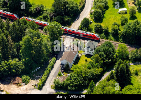 Aerial view of the unrestricted level crossing with former railway station house at Rumbeckerhammer Rumbeck in Arnsberg in Sauerland in the state of N Stock Photo