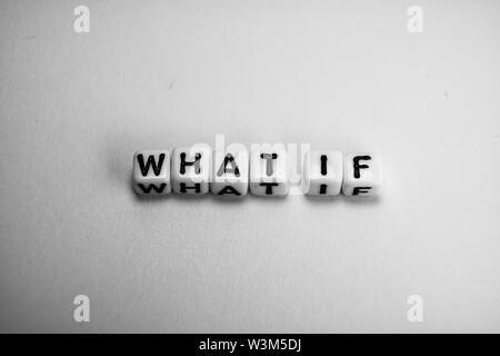 White cubes with question WHAT IF on white paper background and dark shadows Stock Photo