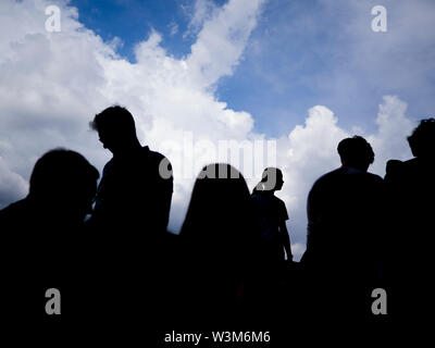 A silhouette of a group of people with in the background Stock Photo