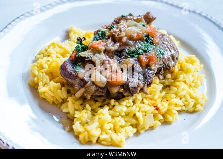 Osso Buco, Veal Shanks that are Braised in Wine with Milanese Saffron Risotto. Traditional Food. Stock Photo