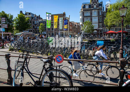 Amsterdam, Netherlands, city centre, old town, cyclist on the Nieuwendijk, parked bike despite parking ban, Stock Photo