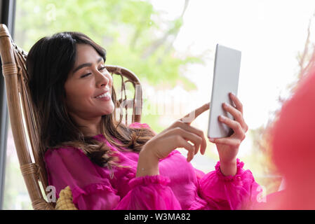 Woman using digital tablet Stock Photo