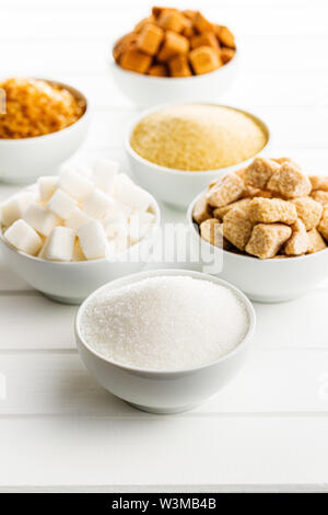 Brown and white sugar on white table. Stock Photo