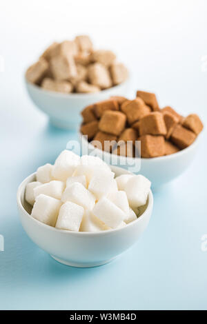 Brown and white sugar on blue table. Stock Photo