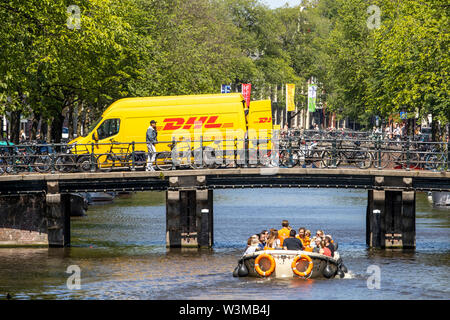 Amsterdam, Netherlands, downtown, old town, DHL courier vehicle, delivers parcels, on a bridge over a canal,