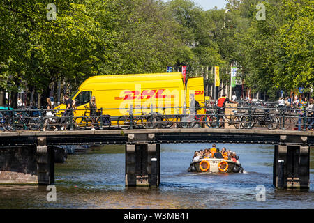 Amsterdam, Netherlands, downtown, old town, DHL courier vehicle, delivers parcels, on a bridge over a canal,