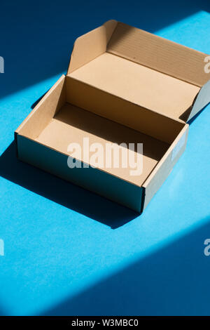 High angle view of empty cardboard box on blue background Stock Photo