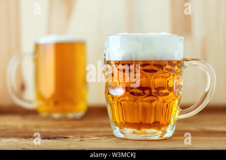 Two full jugs of beer on bar counter, selective focus Stock Photo