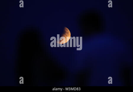 A partial lunar eclipse is visible above London from Primrose Hill, on ...