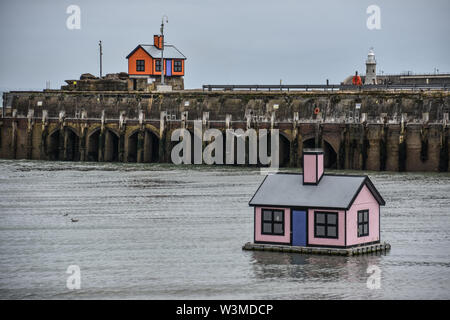 Artwork, part of the Holiday Home project, in the harbour at Folkestone, Kent, UK in July 2019 Stock Photo