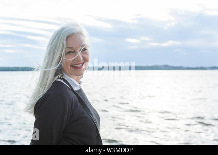Smiling mature woman by Potomac River in Washington DC, USA Stock Photo