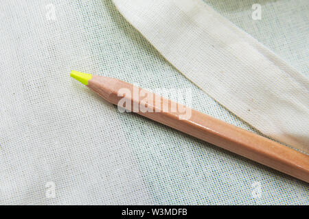 Top surface brown pencil . Yellow colored pencil One single object, top view, bright tint. Yellow color pencil on white background. Stock Photo