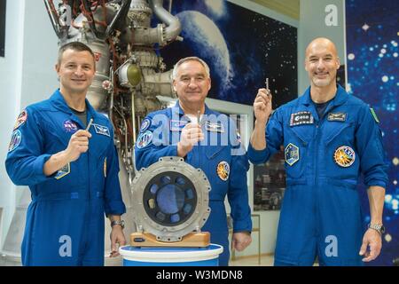 Baikonur, Kazakhstan. 16th Jul 2019. International Space Station Expedition 60 prime crew members Drew Morgan of NASA (left), Alexander Skvortsov of Roscosmos, (center) and Luca Parmitano of the European Space Agency, (right) pose holding replicas of launch keys used to ignite the rocket at the Baikonur Cosmodrome July 16, 2019 in Baikonur, Kazakhstan. Morgan, Skvotsov and Parmitano are expected to launch July 20th on the Soyuz MS-13 spacecraft to the International Space Station. Credit: Planetpix/Ģ����ý Live News Stock Photo