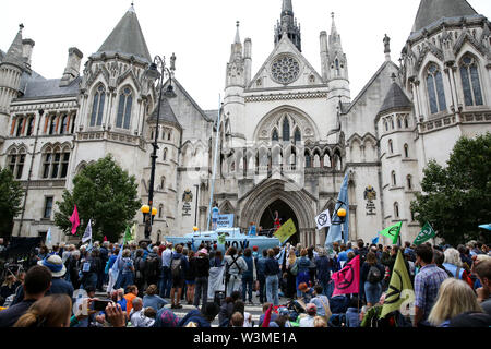 Hundreds of Extinction Rebellion climate change activists gather outside the Royal Courts of Justice during the protest.Hundreds of Extinction Rebellion climate change activists protests outside the Royal Courts of Justice demanding the legal system to take responsibility in the climate change crisis, and ensure the safety of future generations by making ecocide law. The environmental group is staging similar protests in Leeds, Cardiff, Glasgow, Bristol, Norwich and other cities around the country. Stock Photo