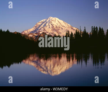 USA, Washington, Mt. Rainier National Park, Sunset light on northwest side of Mt. Rainier is reflected in Eunice Lake. Stock Photo