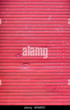 A old closed broken red roller shutter Stock Photo