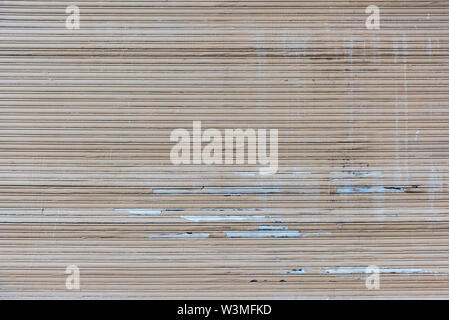 A old closed broken brown roller shutter Stock Photo