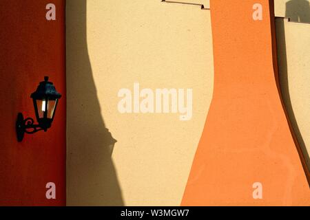 Abstract shapes formed by strong sunlight on a colourfully painted wall, Menorca Spain EU Stock Photo