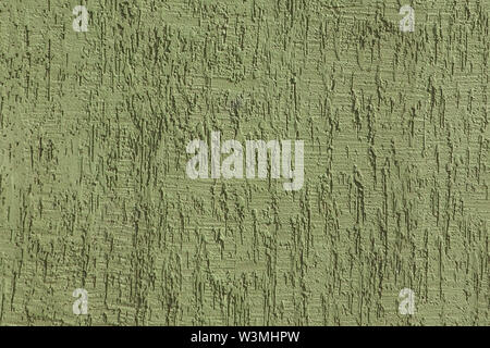 Fragment of the house wall covered with textured plaster. Textured green color handmade surface for background. Stock Photo