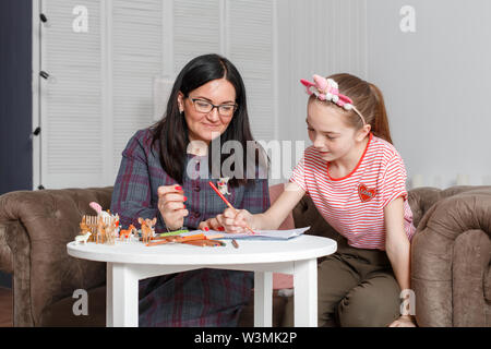Teen girl on reception at the psychotherapist. Psychotherapy session for children. The psychologist works with the patient. The girl draws pencil with Stock Photo