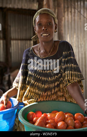 A woman sells vegetables in a local market in Juba, the capital of South Sudan. She took a loan of 500 Sudanese Pounds from BRAC and after paying it back, she recently took another loan of 1000 Sudanese Pounds. She invested the money in her business, which increased her profit margin. December 13, 2008. Stock Photo