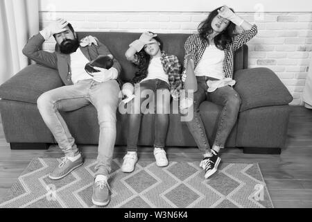 Cleaning all day exhausting occupation. Tired parents and kid. Exhausting cleaning day. Family mom dad and daughter with cleaning supplies sit on couch. Family care about cleanliness. Finish cleaning. Stock Photo