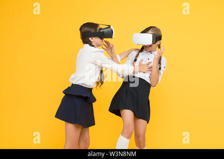 Using VR technologies. children wear wireless VR glasses. future education. back to school. Digital future and innovation. virtual reality. small girls in VR headset. Happy kids use modern technology. Stock Photo