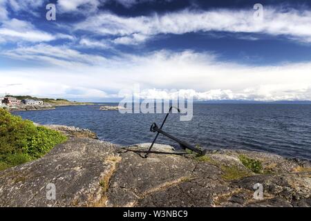 Ship Anchor, Sweeping Landscape View and Dramatic Sky over Strait of Juan De Fuca from Saxe Point Park in Victoria BC Canada, Vancouver Island Stock Photo