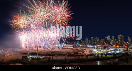 CALGARY, CANADA - JULY 14, 2019: Colorful firework display over the night sky with the Calgary downtown skyline in the backdrop during the annual Calg Stock Photo